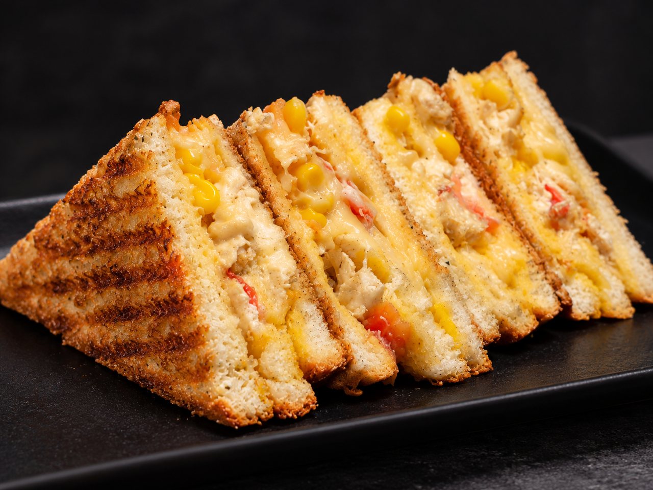 Golden toasted sandwich triangles filled with melted cheese.